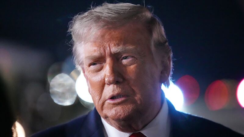 President Donald Trump talks with reporters before boarding Air Force One at John F. Kennedy...